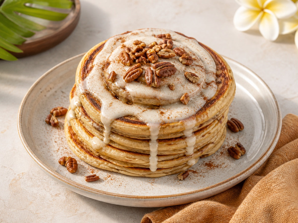 Cinnamon Roll mochi pancakes with glaze and toasted pecans.